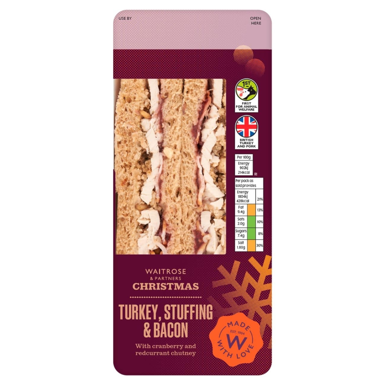 A Waitrose Christmas Turkey, Stuffing and Bacon sandwich in a dark red pack with the sandwich visible through a clear window